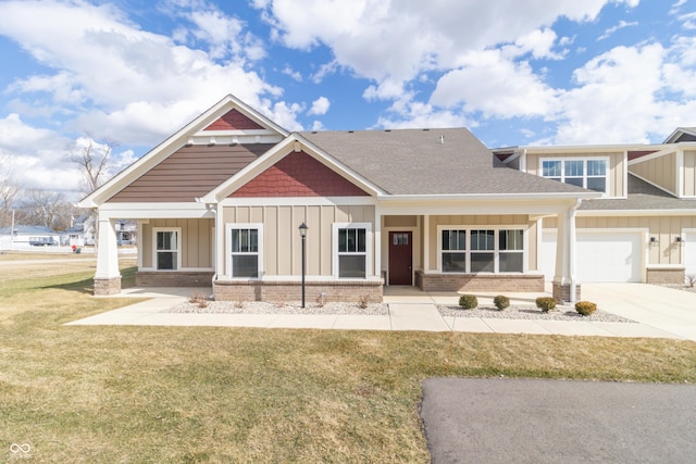 craftsman-style home featuring covered porch, board and batten siding, and a front yard