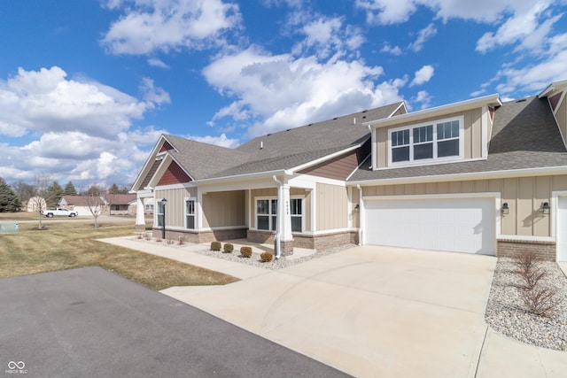 craftsman-style home featuring board and batten siding, brick siding, driveway, and an attached garage