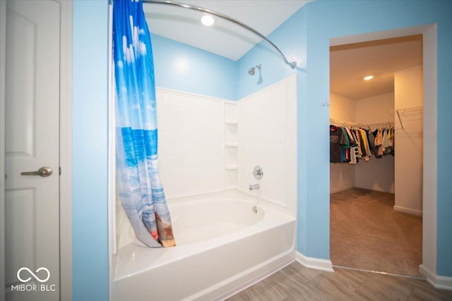 10202 Meadow Path Ln, Indianapolis, IN 46239 - bathroom featuring shower / bathtub combination with curtain, baseboards, and a walk in closet