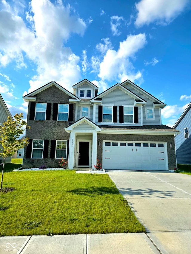 10202 Meadow Path Ln, Indianapolis, IN 46239 - view of front of home with an attached garage, concrete driveway, and a front lawn