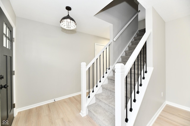 stairs featuring baseboards and wood finished floors