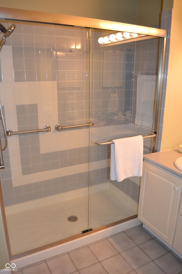 bathroom featuring a stall shower, vanity, and tile patterned floors