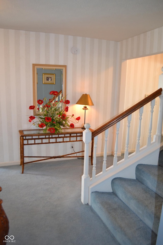 stairs featuring baseboards, carpet floors, and wallpapered walls