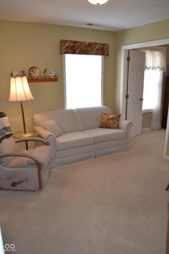 carpeted living room with visible vents