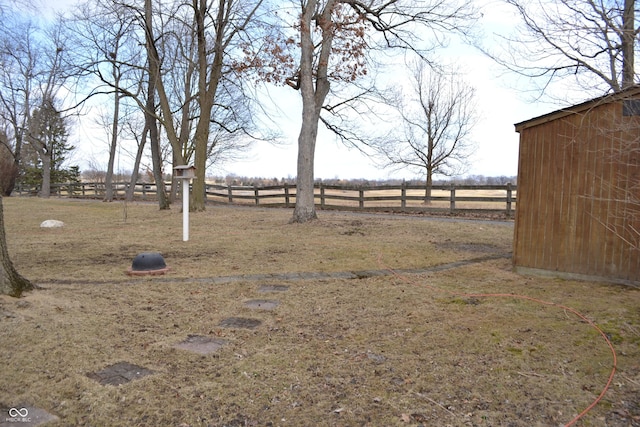 view of yard with a rural view and fence