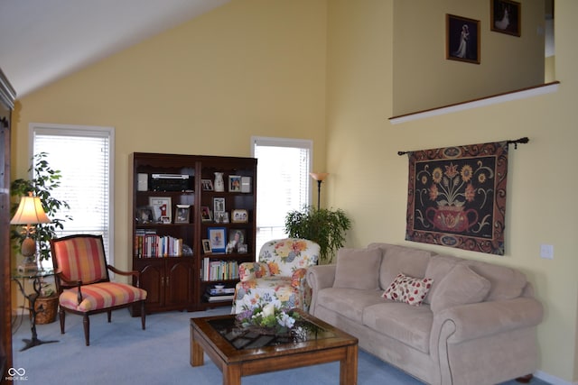 living area featuring carpet, high vaulted ceiling, and plenty of natural light