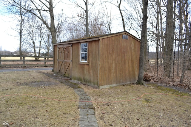 view of shed featuring fence