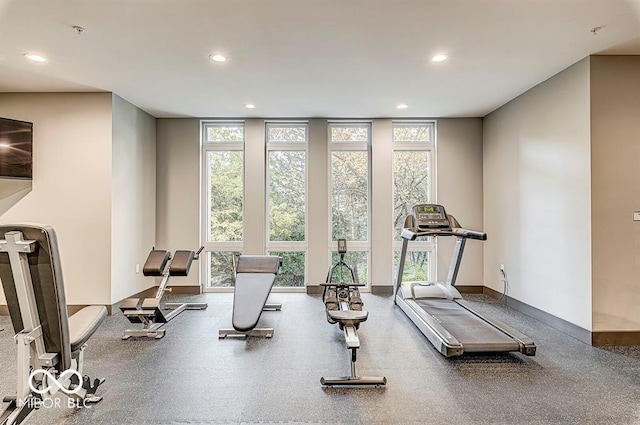 exercise area with a wall of windows, a healthy amount of sunlight, and recessed lighting