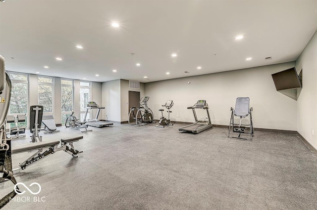 exercise room with a wall of windows, recessed lighting, baseboards, and visible vents