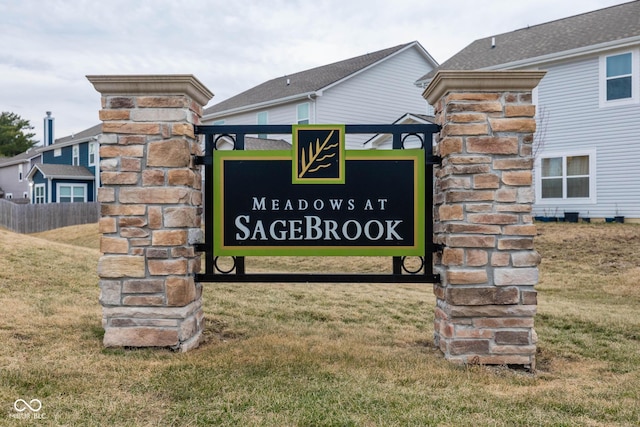 community / neighborhood sign featuring a lawn