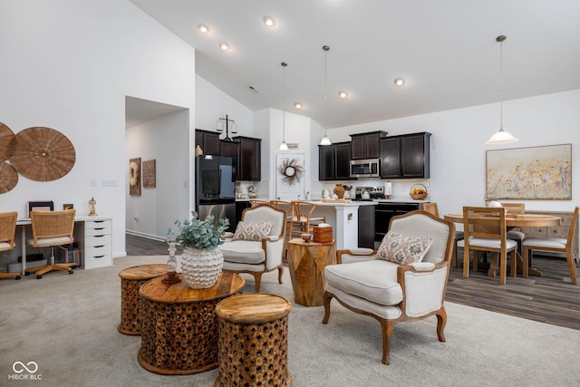 living room with high vaulted ceiling, carpet flooring, and recessed lighting