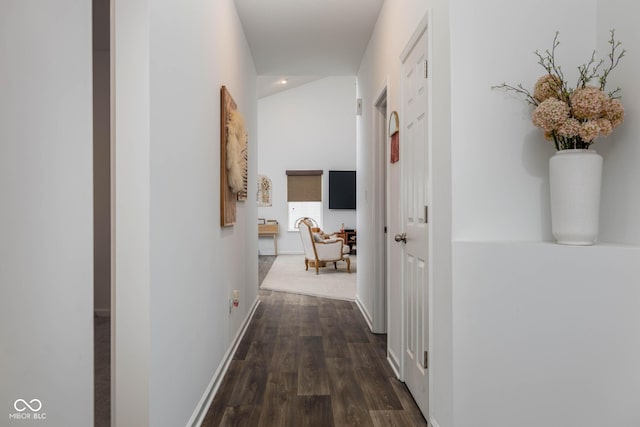 hallway with dark wood-style flooring and baseboards