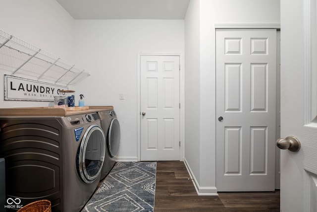 laundry area featuring dark wood-style floors, laundry area, independent washer and dryer, and baseboards