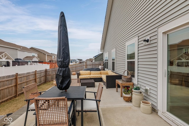 view of patio with a fenced backyard, an outdoor hangout area, and outdoor dining space