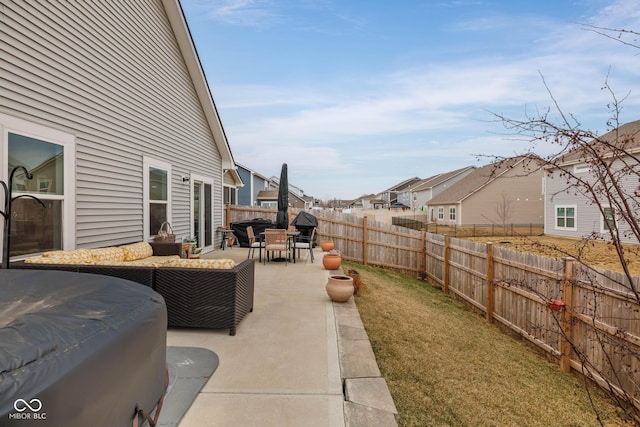 view of patio / terrace featuring a fenced backyard, a residential view, and an outdoor living space