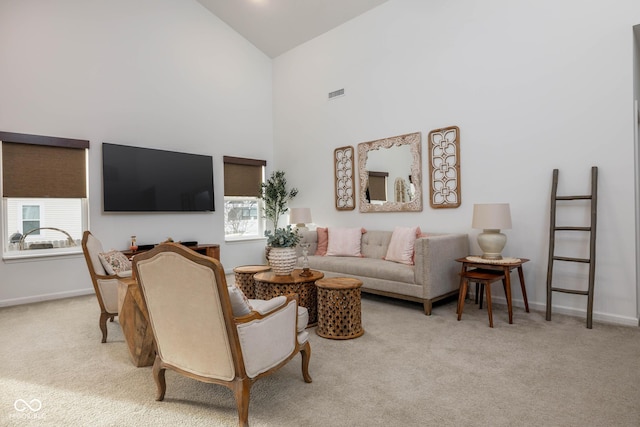 carpeted living room featuring high vaulted ceiling, visible vents, and baseboards