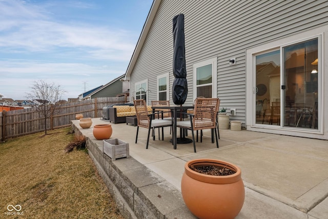 view of patio featuring fence and an outdoor hangout area