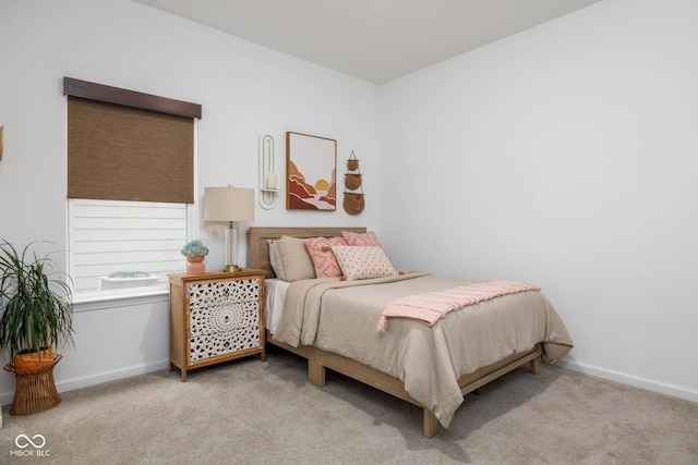 bedroom featuring carpet floors and baseboards