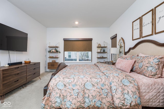 bedroom with light carpet and visible vents