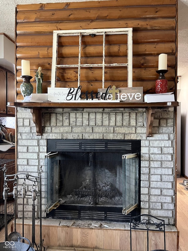 details with rustic walls, crown molding, a fireplace, and wood finished floors