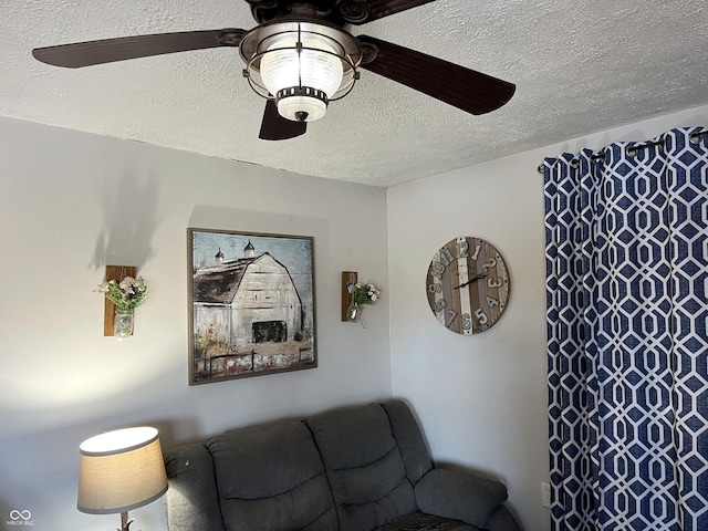 living area with a textured ceiling and a ceiling fan