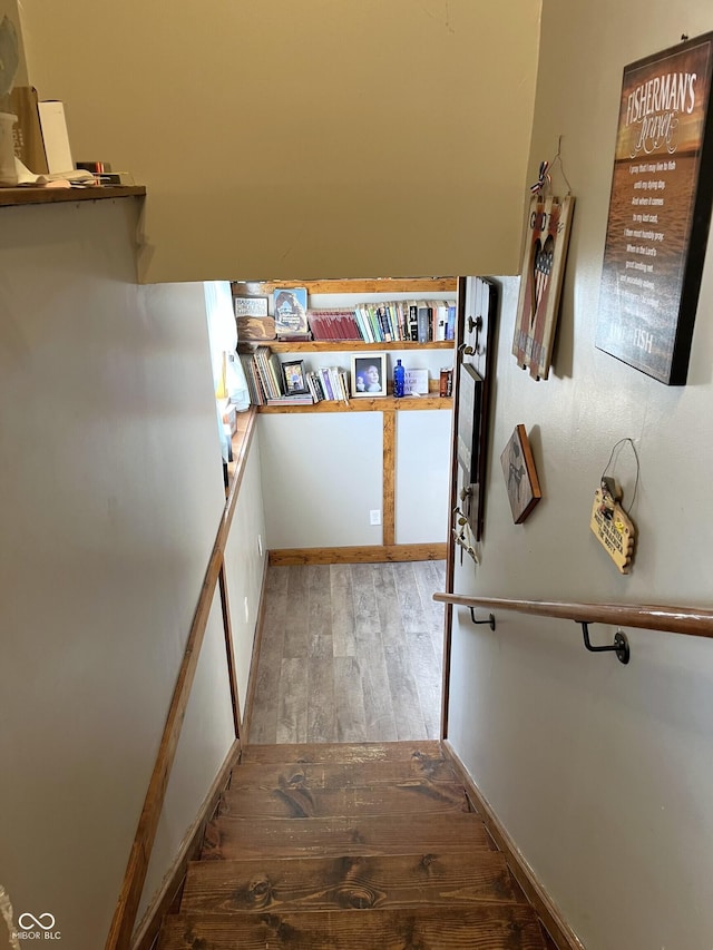 stairway featuring wood finished floors