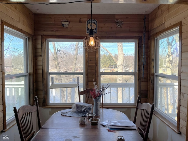 dining room with wooden walls