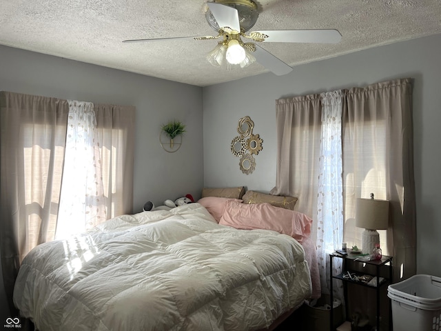 bedroom featuring a textured ceiling and ceiling fan