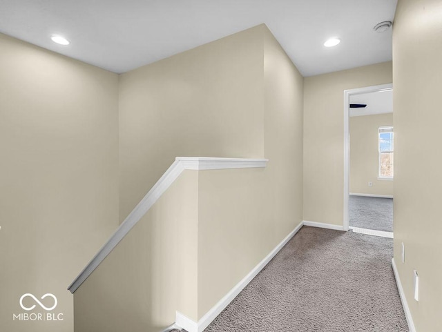 hallway with recessed lighting, baseboards, carpet flooring, and an upstairs landing