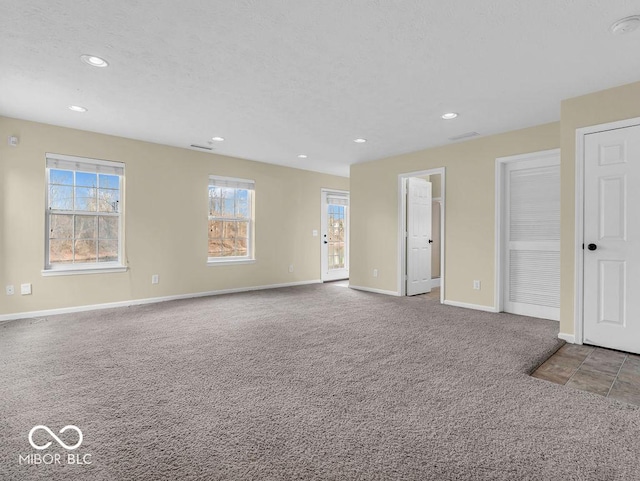 empty room featuring baseboards, carpet flooring, and recessed lighting