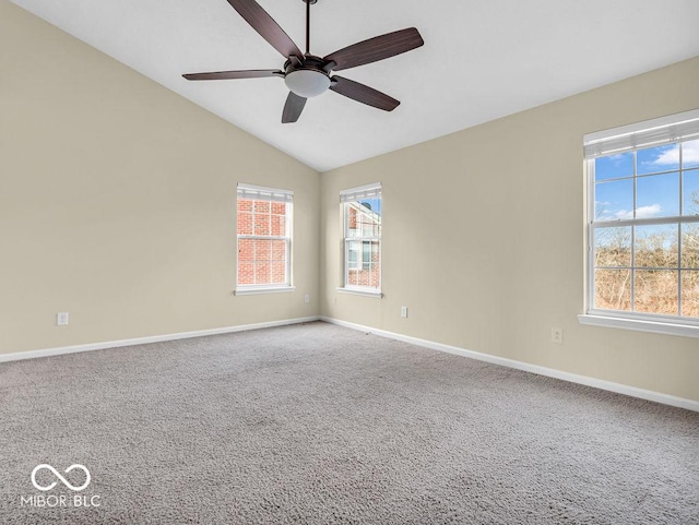 spare room featuring a ceiling fan, lofted ceiling, carpet flooring, and baseboards