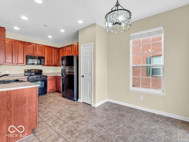 kitchen featuring recessed lighting, light countertops, a sink, black appliances, and baseboards