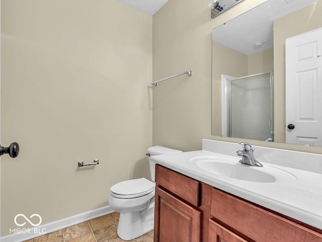 full bathroom with a stall shower, baseboards, toilet, tile patterned floors, and vanity