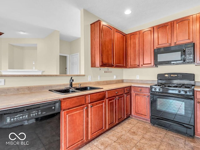 kitchen with light tile patterned floors, recessed lighting, a sink, light countertops, and black appliances