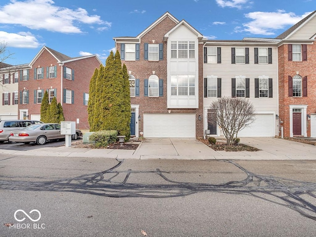 11936 Esty Way, Carmel, IN 46033 - view of property featuring driveway, a garage, and brick siding