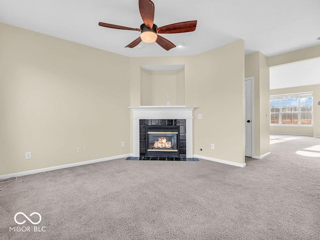 unfurnished living room with carpet floors, a fireplace, and baseboards