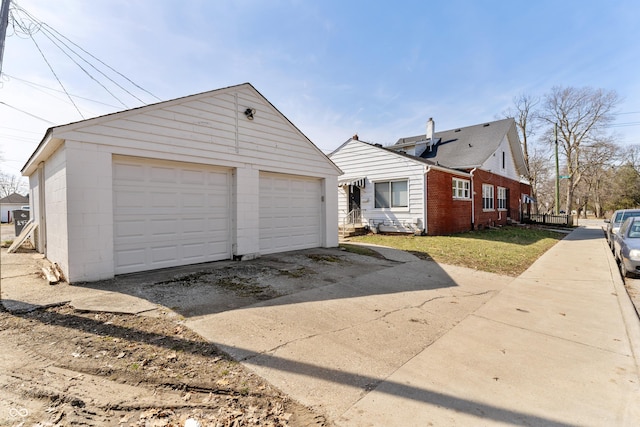 view of property exterior featuring a detached garage and an outdoor structure