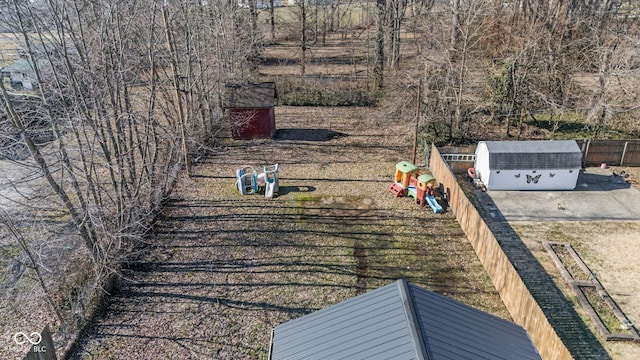 view of yard with fence and an outdoor structure