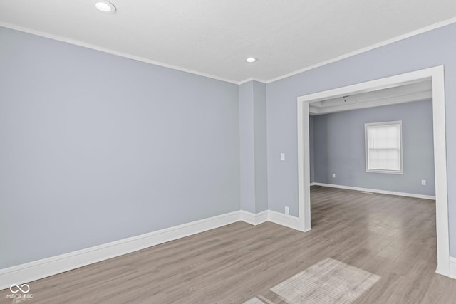 empty room featuring ornamental molding, recessed lighting, wood finished floors, and baseboards