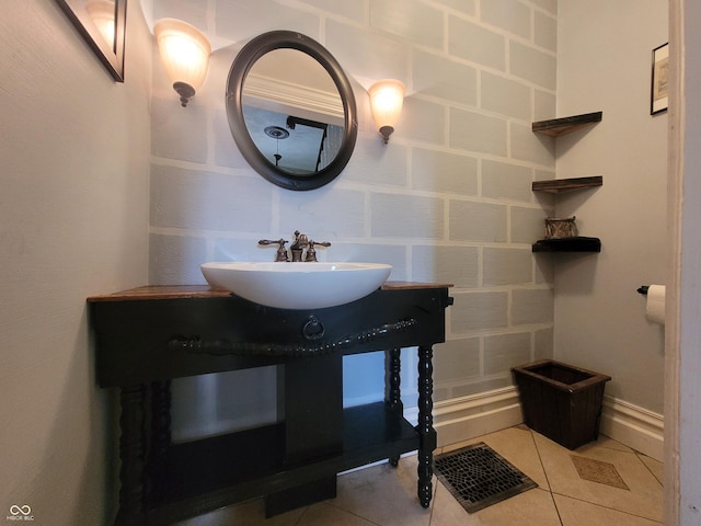 608 E Main St, Crawfordsville, IN 47933 - bathroom with visible vents, a sink, and tile patterned floors
