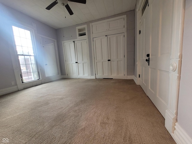 608 E Main St, Crawfordsville, IN 47933 - unfurnished bedroom with carpet floors, multiple closets, and a ceiling fan