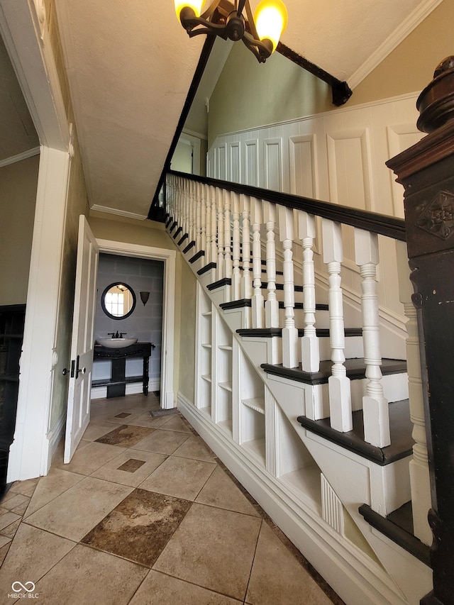 stairway featuring vaulted ceiling, crown molding, and tile patterned floors