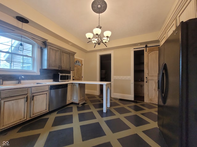608 E Main St, Crawfordsville, IN 47933 - kitchen featuring light floors, light countertops, a barn door, appliances with stainless steel finishes, and a sink