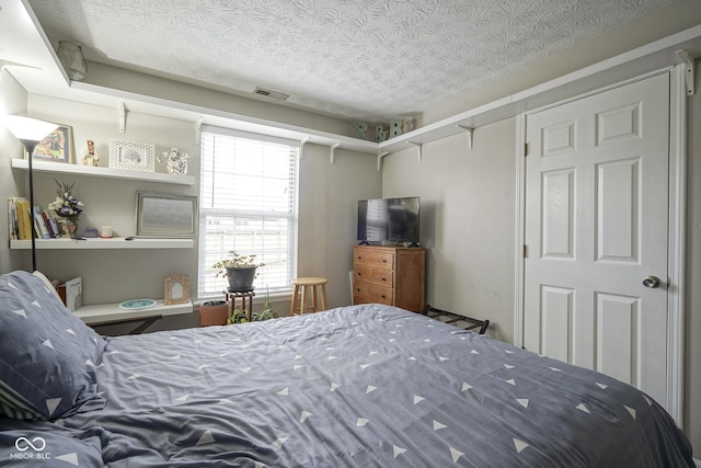 bedroom with visible vents and a textured ceiling