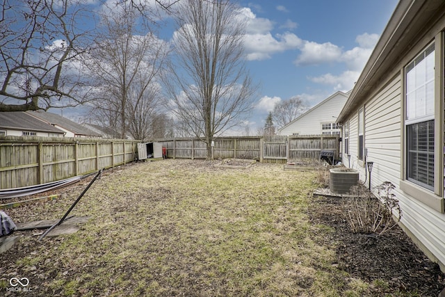 view of yard featuring central air condition unit and a fenced backyard