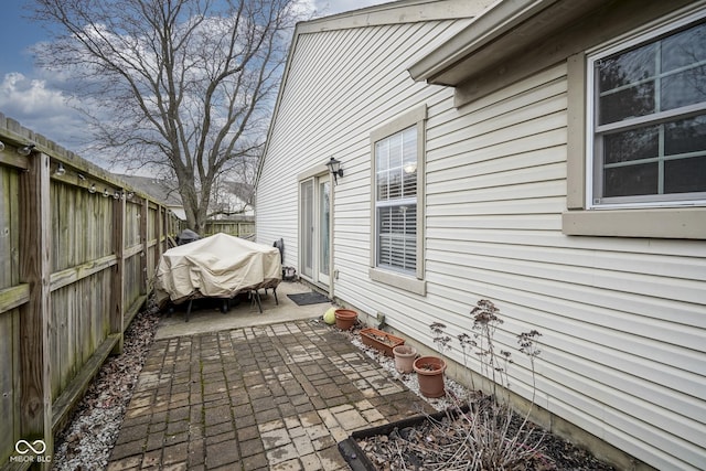 view of property exterior featuring a patio and a fenced backyard