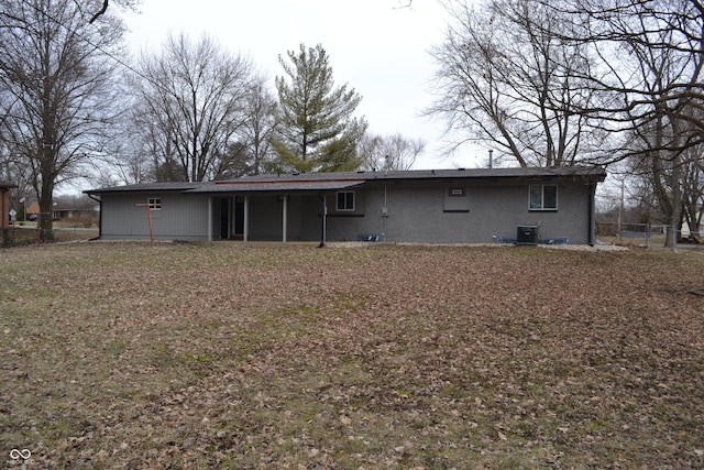 rear view of property featuring fence and central air condition unit