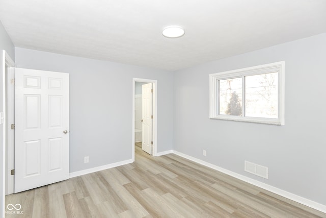 unfurnished bedroom featuring light wood-type flooring, baseboards, and visible vents