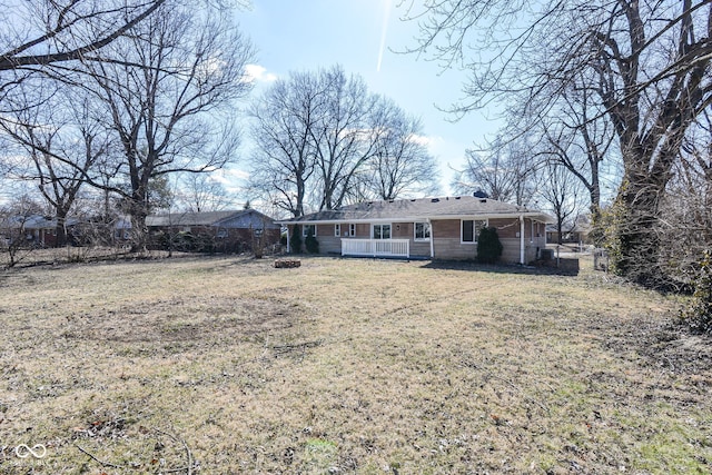 rear view of property with a yard