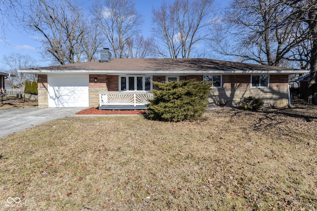 ranch-style home featuring a garage, brick siding, driveway, a chimney, and a front yard